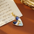 Vintage heart pendant with blue starry sky enamel and golden rose on leather background - Dark Blue and White Heart Rose Style