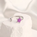 Detailed macro view of silver star ring with purple enamel inlay on white stone - Adjustable Open / Steel Color Star Purple