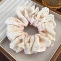 Detail of the pink satin scrunchie with beige embroidered lace edges on a jewelry box - Pink Beige Double Layer Embroidery Style