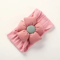 Detailed close-up of pink nylon headband with jacquard flower and soft knitted texture - Deep Pink