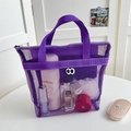 Purple mesh cosmetic bag with playful eye patch design and sturdy woven handles - Handbag Style / Purple