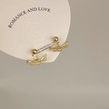 Detailed close-up of vintage golden earrings featuring an irregular textured bar design - Irregular Texture Bar