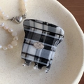 Classic black and white checkered hair claw clip with elegant oval silver metal logo - 4.5CM