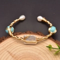 Pulsera artesanal de hilo dorado con perla barroca y turquesa sobre base madera - Pulsera Barroca Cuadrada Turquesa