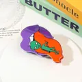 Detailed view of creative alien acrylic hair claw clip on decorative book background - Purple Orange Mouth Alien
