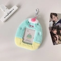 Close-up of plush photo card holder with mint and yellow contrast and pink ball charm - Green