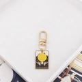 Detail of The Wheel of Fortune tarot card keychain with golden enamel alloy finish - The Wheel of Fortune