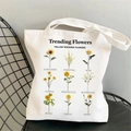 White canvas tote bag featuring yellow floral illustrations on a minimalist wire chair - STD704-D Yellow Illustration
