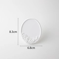 White oval plaster jewelry display stand with embossed floral patterns for earrings - Laced Earring Stand Large