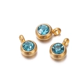 Detail of three gold earrings with sparkling blue zircon stones and round drop pendants - 10 Pieces per Pack / Gold Border Lake Blue Stone