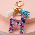 Detail of resin letter H keychain with multi-color crushed stones and soft tassels - Letter H