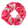 Close-up of pink Christmas hair scrunchie with Santa and gift prints on satin fabric - Rose Red