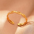 Detailed view of bohemian golden twisted rope ring on warm silk fabric background - Gold Twisted Braid (C1467)