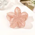 Detailed macro shot of a pink floral hair claw clip with a glossy translucent finish - Jelly Pink