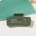 Detail view of dark green matte rectangular hollow hair claw clip on fan background - A178 XL Matte Square - Army Green