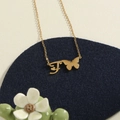 Gold stainless steel butterfly initial F necklace featuring a delicate cross chain - Gold F