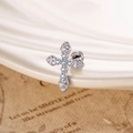 Silver cross stud earring with light blue cubic zirconia on a white ceramic plate - Light Sea Blue (1 Pc)