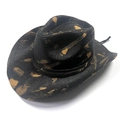 Detailed texture of black woven straw cowboy hat with vintage brushed tan patterns - Black Gold Splash/Black Band