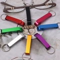 Colorful aluminum alloy keychain bottle openers in a circular arrangement on fabric - Assorted Colors (8.5g)