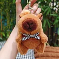 Plush brown capybara keychain with a striped bow tie and silver metal ring accessory - With Backpack