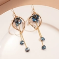 Detail of twisted gold diamond frame earrings with iridescent blue crystals and long chains - Gold Ear Hook (Blue Crystal)