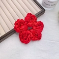 Elegant red woven floral satin scrunchie shown in a stylish lifestyle setting - Flower / Red