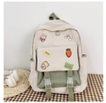 Detail of canvas backpack featuring pastel patchwork design and decorative cute patches - Green +5a Badge