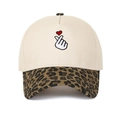 Close-up detail of heart finger embroidery and leopard print brim on a cream baseball cap - Beige/Leopard