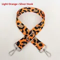 Detail view of light orange leopard print nylon bag strap with silver metal hooks - Light Orange + Silver Hook
