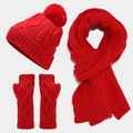 Detailed view of red cable knit texture on winter hat, scarf, and fingerless gloves set - Red