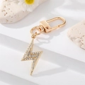 Portachiavi fulmine dorato con strass di cristallo su base bianca - Fulmine con Strass