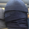 Navy and light grey corduroy dockers caps stacked to show ribbed texture and material - Navy Blue