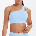 Close-up of light blue one-shoulder sports bra with asymmetric cutout and wide hem band - Sky Blue