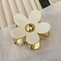 Elegant white acetate flower hair claw clip with gold metal center for hair styling - Cream