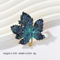 Blue rhinestone maple leaf brooch in gold finish, dimensions 4.7cm x 4.5cm - Blue Maple Leaf