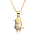 Detail of a golden penguin pendant with micro-pave crystals on a white reflective base - Penguin Shape (B405)