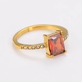 Close-up of a gold-plated ring featuring a rectangle red gemstone and small side crystals - US 7 / Gold/Red Zirconia