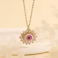 Detail of 18K gold plated evil eye necklace with pink and blue stones on sand background - Pink Purple Flower-E3