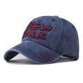 Detailed close-up of premium 3D New York embroidery on washed cotton baseball cap - Navy Blue