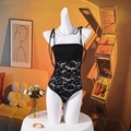 Detailed view of black lace patchwork bodysuit with adjustable thin straps on a mannequin - S / Black