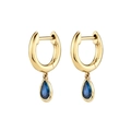 Detailed macro view of gold hoop earrings with sparkling blue teardrop zircons on white backdrop - Blue