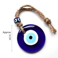 Detailed view of 8cm glass Evil Eye wall hanging with natural jute rope and decorative bead - 8CM Medium Pendant