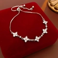 Macro detail of adjustable silver snowflake bracelet with sparkling zircon stones - Pull-out Adjustment / Silver White Flower