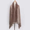 Close-up of light brown shawl with faux rabbit fur collar and fringed tassels on a mannequin - Camel