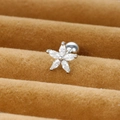 Macro shot of a flower zircon stud earring with screw back on brown velvet padding - Silver / White Zirconia