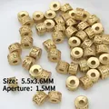 Macro shot of gold cylinder spacer beads with relief patterns for DIY jewelry making - 16 (5.5mm Scripture Matte Bead)