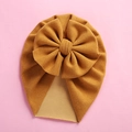 Detailed flat lay of ginger yellow knit baby turban hat with oversized bow on pink background - 18*21cm / Ginger Yellow