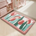 Plush bathroom mat with pink and green tulip pattern on a wooden floor - Wild Tulip