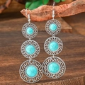 Detail of vintage bohemian drop earrings with turquoise stones hanging on a branch - Triple Loop Hollow Drop (HQEF-1260)