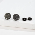 Detailed view of matte black baseball-patterned stainless steel stud earrings on stone - Baseball / Black